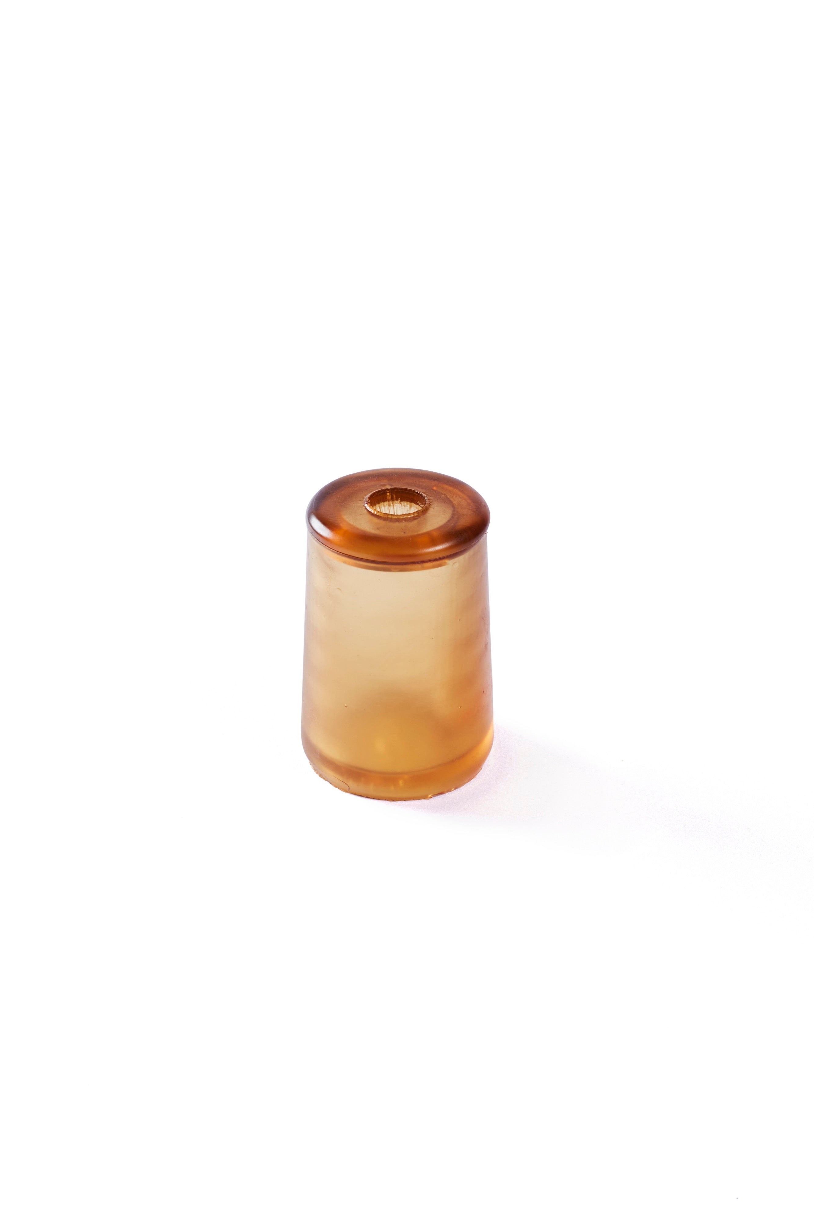 A small rubber gleba urn in a clear amber.